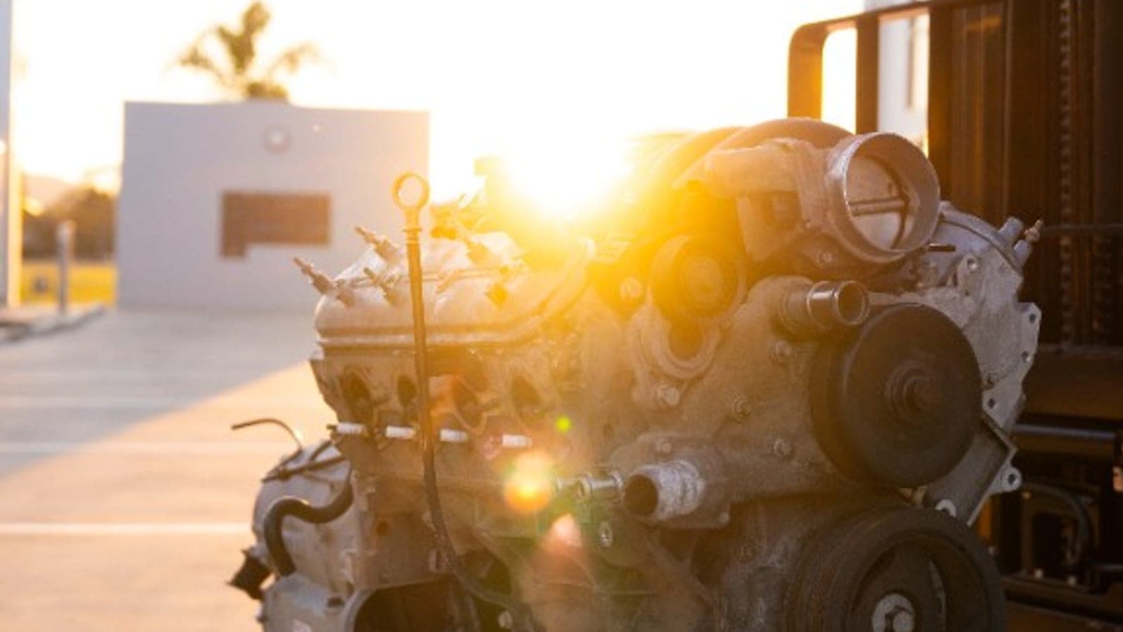 The L98 6.0-litre V8 on a pallet, backlit by the setting sun
