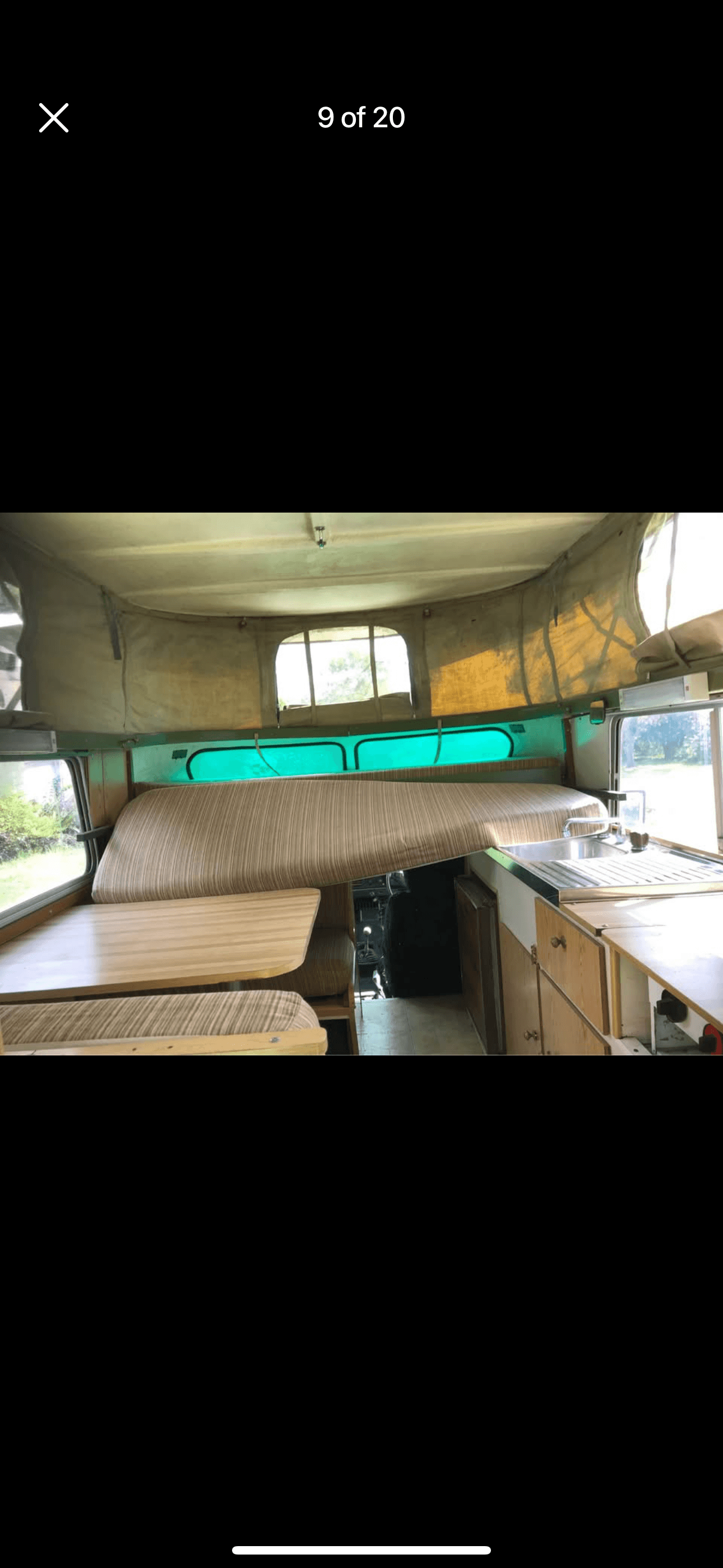 The original 1978 Chinook interior with pop-top raised, showing the dinette, overcab bed and vintage canvas
